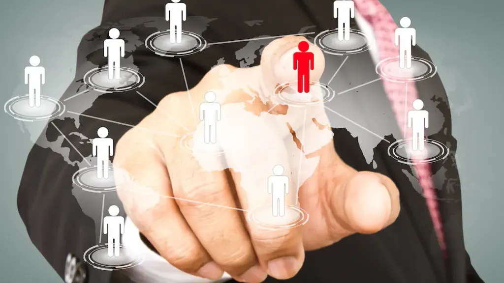 PEO Bangladesh – Businessman selecting an employee icon on a virtual global network map, representing services by a Professional Employer Organization.